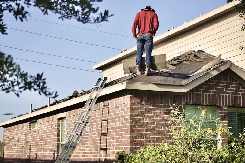 Professional roofer working on a residential roof in Fontana